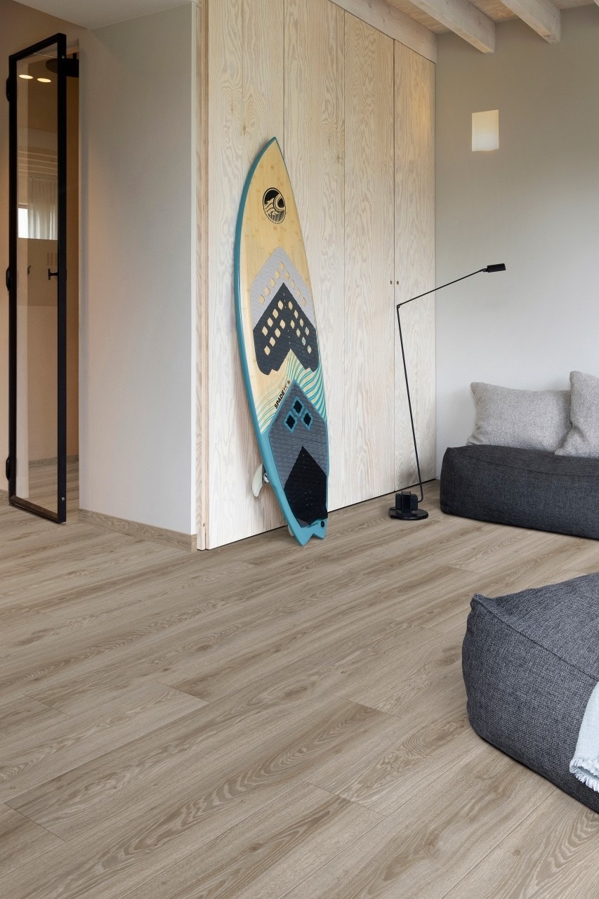 Light oak-effect LVT plank flooring in a coastal-style living room